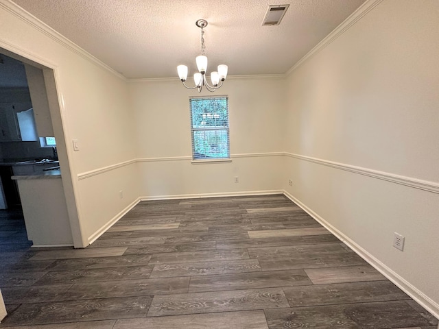 4917 Cavan Pl, Grovetown, GA 30813 - unfurnished dining area with ornamental molding, wood finished floors, a chandelier, a textured ceiling, and baseboards