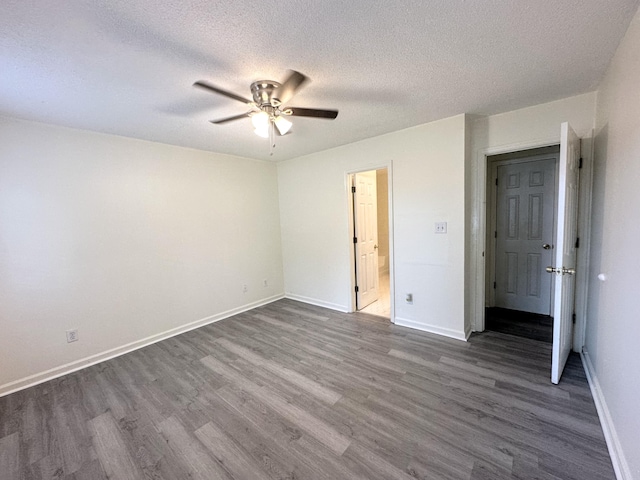 4917 Cavan Pl, Grovetown, GA 30813 - unfurnished bedroom with dark wood-type flooring, a textured ceiling, baseboards, ensuite bath, and ceiling fan