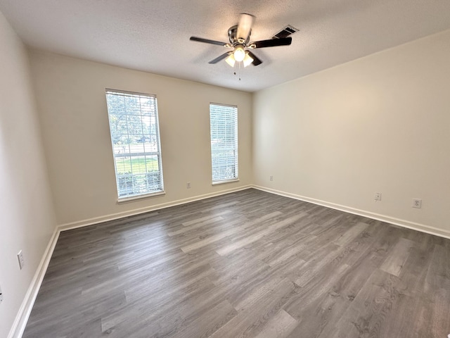 4917 Cavan Pl, Grovetown, GA 30813 - empty room featuring dark wood-style floors, a textured ceiling, a ceiling fan, and baseboards