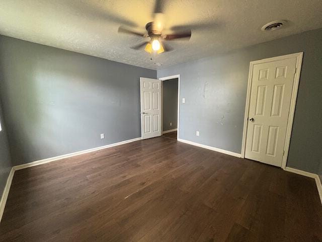 2009 Ryan Rd, Augusta, GA 30904 - unfurnished bedroom with dark wood-style floors, a textured ceiling, and ceiling fan
