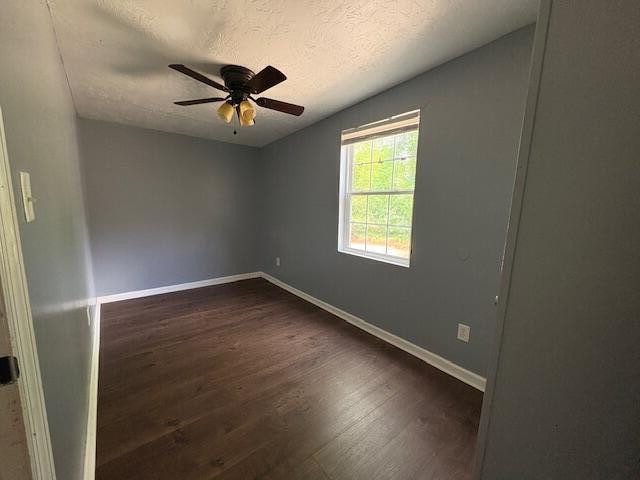 2009 Ryan Rd, Augusta, GA 30904 - unfurnished room featuring a textured ceiling, dark wood-type flooring, and a ceiling fan