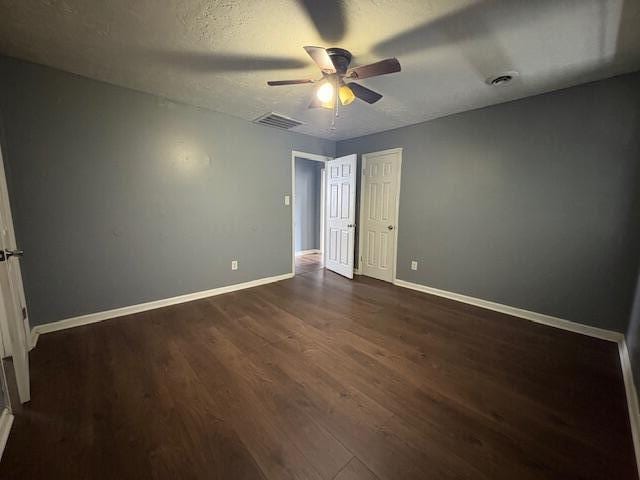 2009 Ryan Rd, Augusta, GA 30904 - unfurnished bedroom featuring dark wood-style flooring, a ceiling fan, a closet, and a textured ceiling