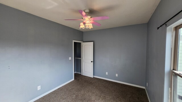 carpeted empty room featuring ceiling fan