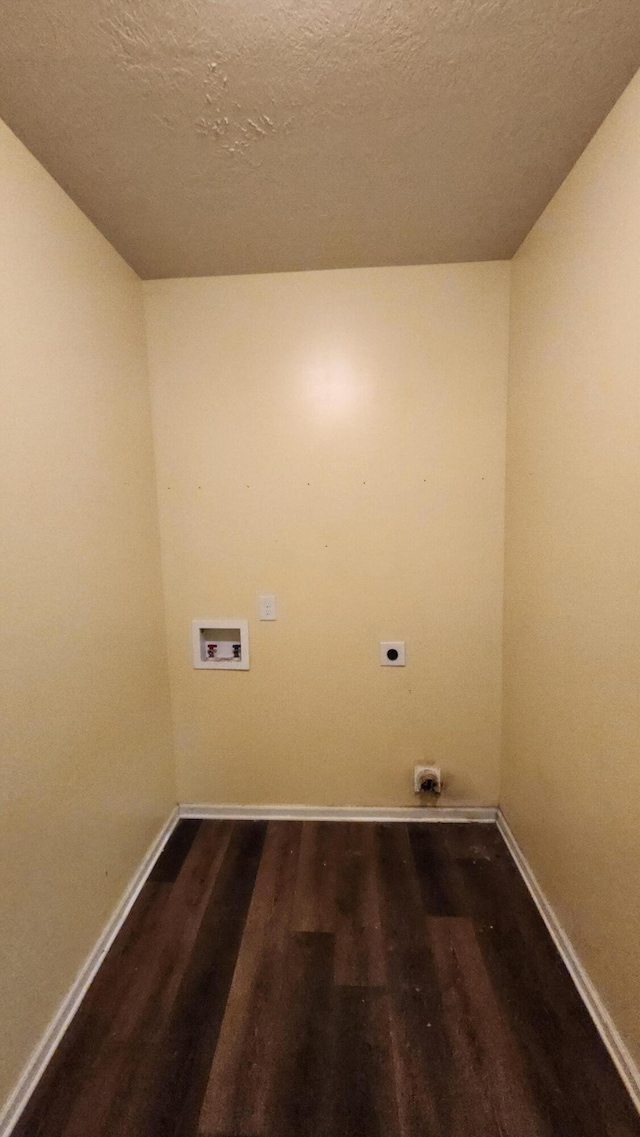 laundry area featuring hookup for a washing machine, a textured ceiling, dark hardwood / wood-style floors, and electric dryer hookup