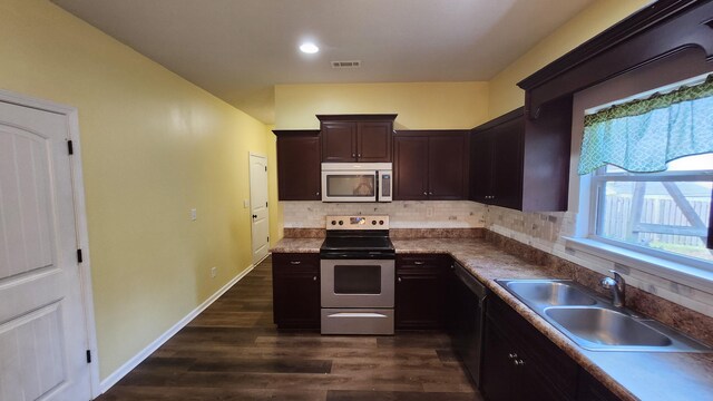 kitchen with dark hardwood / wood-style flooring, backsplash, dark brown cabinetry, stainless steel appliances, and sink