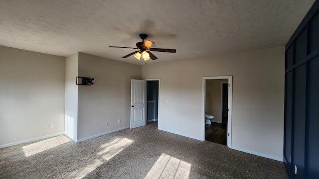 unfurnished bedroom with ensuite bath, ceiling fan, carpet, and a textured ceiling