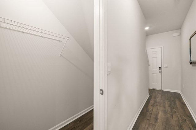 corridor featuring baseboards, dark wood-style floors, and recessed lighting