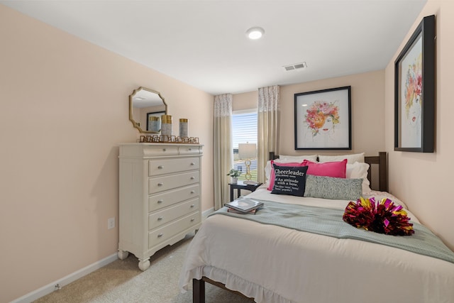 bedroom with carpet floors, visible vents, and baseboards