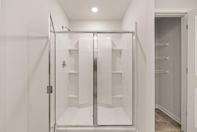 full bathroom with baseboards and a stall shower