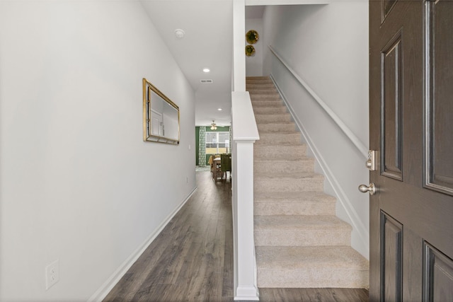 stairway featuring visible vents, baseboards, wood finished floors, and recessed lighting