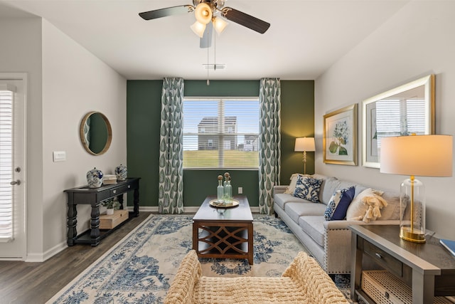 living room with visible vents, baseboards, a ceiling fan, and wood finished floors