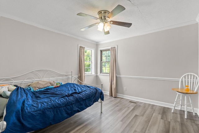 2144 Reedale Ave, Augusta, GA 30906 - bedroom with wood finished floors, ornamental molding, a textured ceiling, a ceiling fan, and baseboards