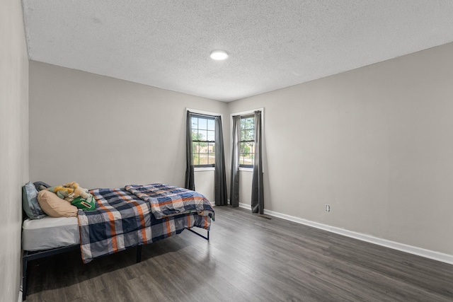 2144 Reedale Ave, Augusta, GA 30906 - bedroom with dark wood-style flooring, a textured ceiling, and baseboards