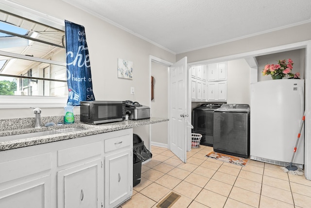 2144 Reedale Ave, Augusta, GA 30906 - kitchen featuring black microwave, freestanding refrigerator, a sink, washing machine and dryer, and ornamental molding