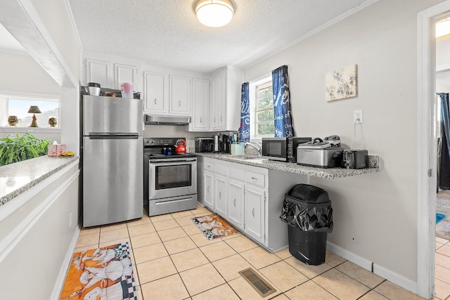 2144 Reedale Ave, Augusta, GA 30906 - kitchen with stainless steel appliances, under cabinet range hood, white cabinetry, light tile patterned floors, and a textured ceiling