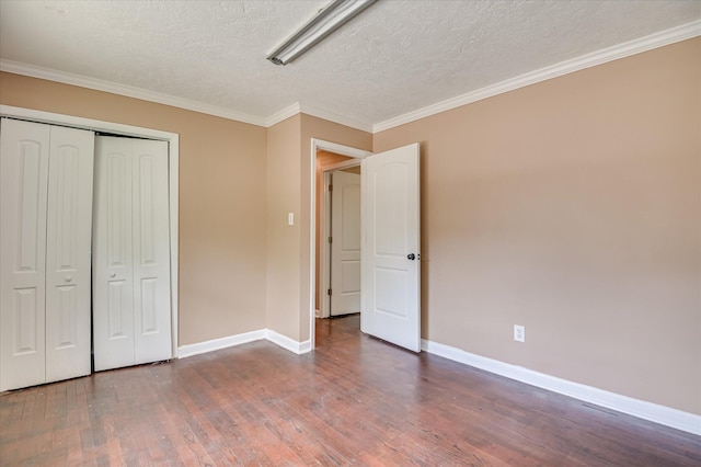 3840 Belair Rd, Augusta, GA 30909 - unfurnished bedroom with wood finished floors, a textured ceiling, ornamental molding, and a closet