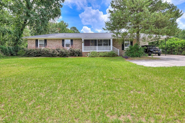 3840 Belair Rd, Augusta, GA 30909 - ranch-style house featuring brick siding, a carport, a front yard, and driveway