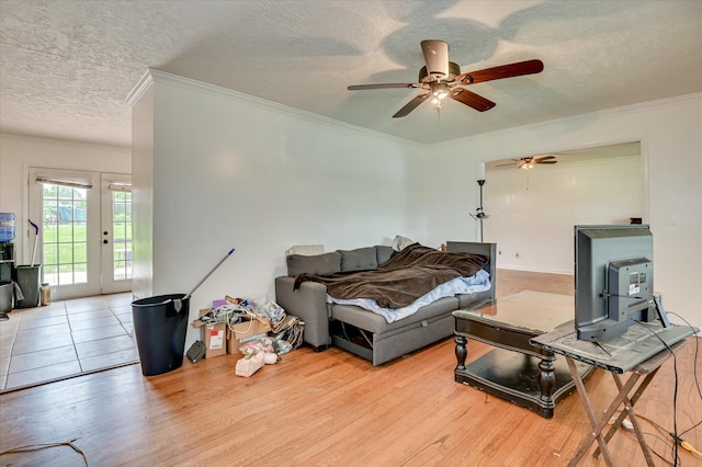 3840 Belair Rd, Augusta, GA 30909 - living room with ornamental molding, a textured ceiling, a ceiling fan, wood finished floors, and french doors