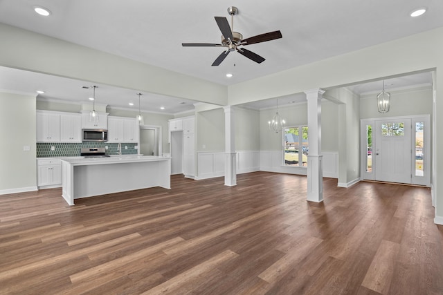 1355 Bellingham Dr, Beech Island, SC 29842 - unfurnished living room featuring ceiling fan with notable chandelier, ornate columns, ornamental molding, dark wood-style floors, and recessed lighting