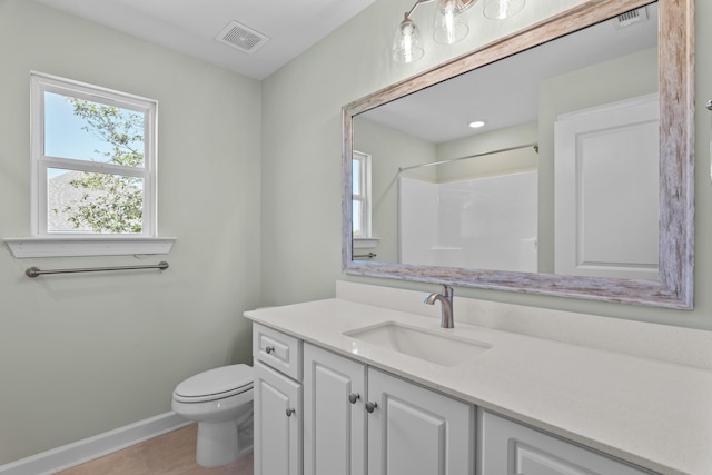 1355 Bellingham Dr, Beech Island, SC 29842 - bathroom featuring visible vents, toilet, vanity, baseboards, and walk in shower