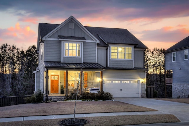 view of front of house featuring covered porch and a garage