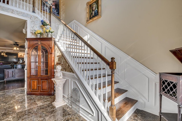 stairs with ornate columns and ceiling fan