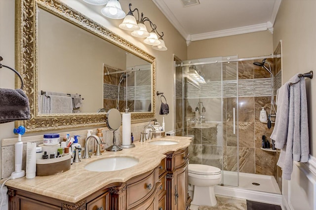 bathroom with backsplash, vanity, a shower with door, crown molding, and toilet