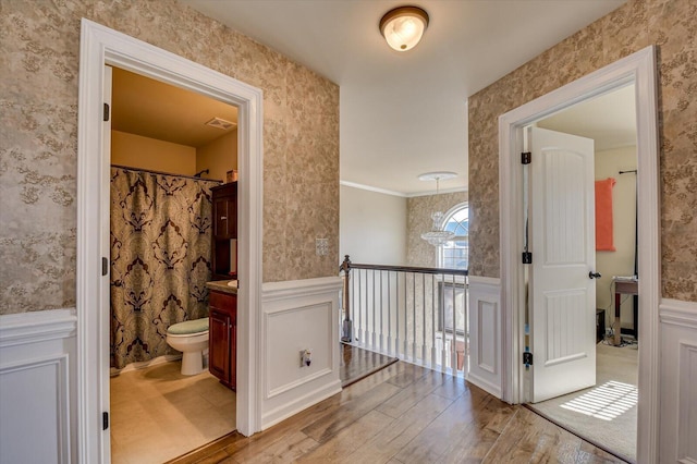 hall featuring light hardwood / wood-style flooring and ornamental molding