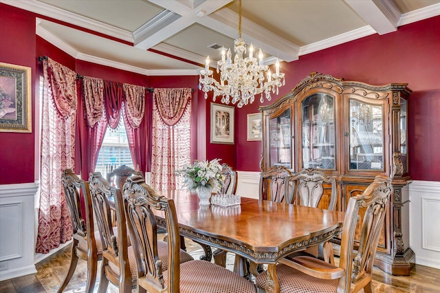 dining room featuring coffered ceiling, an inviting chandelier, crown molding, beam ceiling, and wood-type flooring