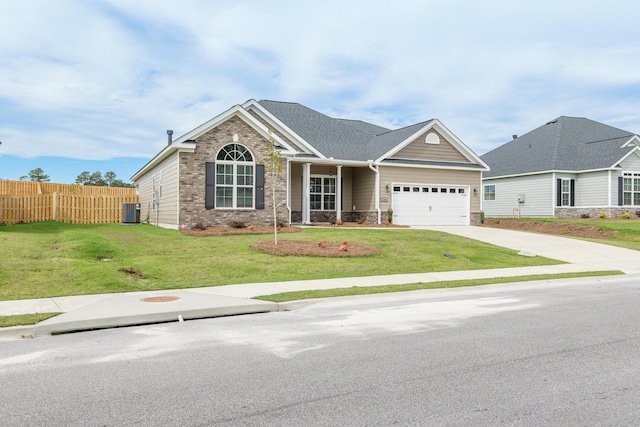 view of front of home with a garage, concrete driveway, fence, a front lawn, and brick siding