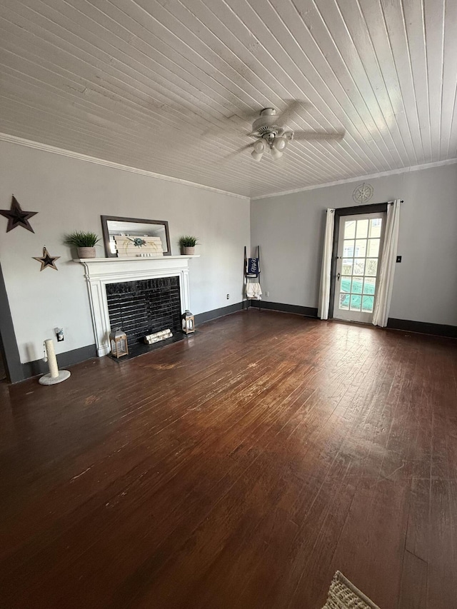 unfurnished living room featuring dark hardwood / wood-style floors, a fireplace, ornamental molding, ceiling fan, and wooden ceiling