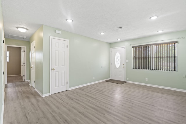 2954 Celeste Dr, Hephzibah, GA 30815 - foyer entrance featuring wood finished floors, a textured ceiling, baseboards, and recessed lighting