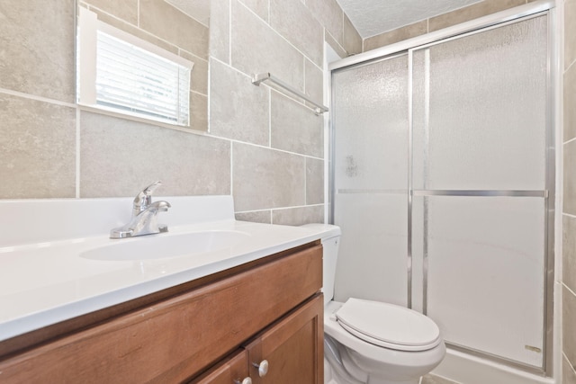 2954 Celeste Dr, Hephzibah, GA 30815 - bathroom featuring tile walls, vanity, toilet, and a stall shower