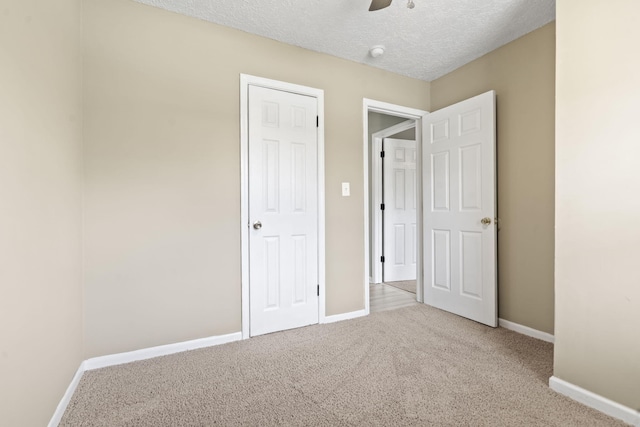 2954 Celeste Dr, Hephzibah, GA 30815 - unfurnished bedroom with carpet flooring, baseboards, a textured ceiling, and a ceiling fan