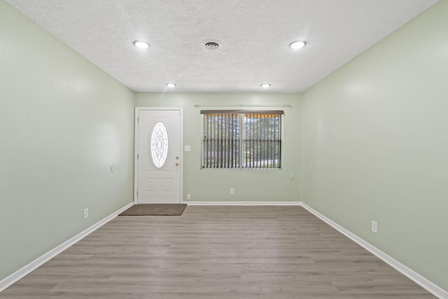 2954 Celeste Dr, Hephzibah, GA 30815 - entryway featuring wood finished floors, baseboards, a textured ceiling, and recessed lighting