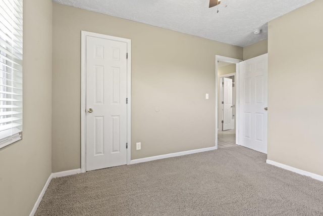 2954 Celeste Dr, Hephzibah, GA 30815 - unfurnished bedroom with carpet, baseboards, a ceiling fan, and a textured ceiling