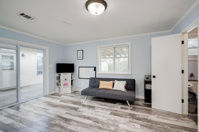 living area featuring ornamental molding and hardwood / wood-style floors