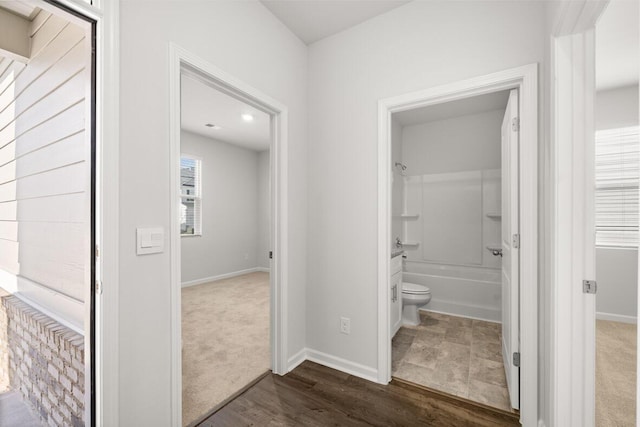 bathroom with shower / tub combination, hardwood / wood-style flooring, and toilet