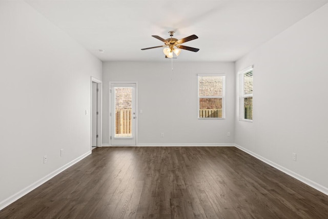 spare room featuring ceiling fan and dark wood-type flooring