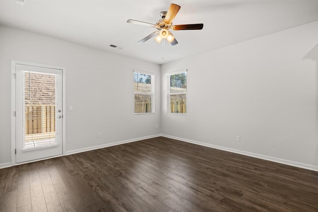 spare room featuring ceiling fan and dark wood-type flooring