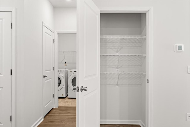 clothes washing area featuring independent washer and dryer and hardwood / wood-style floors