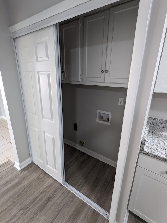 3332 Hillis Rd, Augusta, GA 30906 - clothes washing area featuring hookup for a washing machine, cabinet space, light wood-type flooring, and baseboards