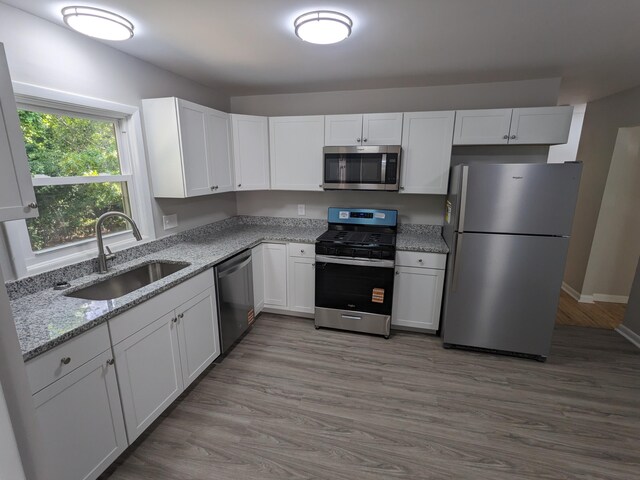 3332 Hillis Rd, Augusta, GA 30906 - kitchen featuring appliances with stainless steel finishes, a sink, white cabinetry, and light stone counters