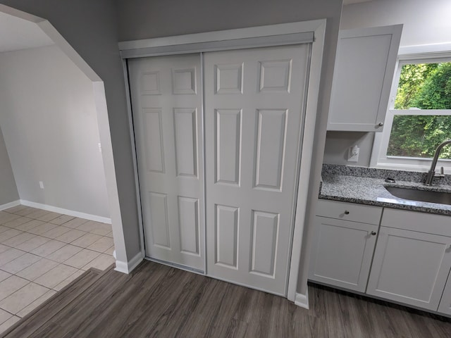 3332 Hillis Rd, Augusta, GA 30906 - kitchen featuring a sink, light stone counters, baseboards, and dark wood finished floors