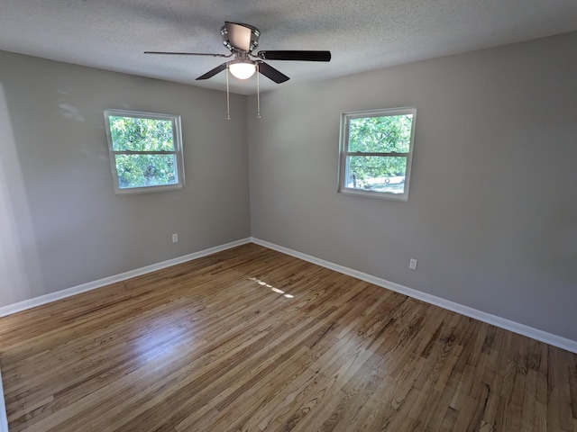 3332 Hillis Rd, Augusta, GA 30906 - unfurnished room featuring healthy amount of natural light, wood finished floors, baseboards, and a textured ceiling