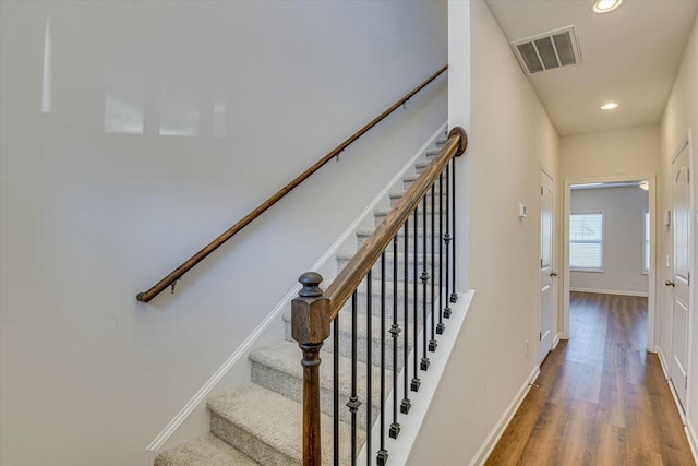 stairs with hardwood / wood-style floors