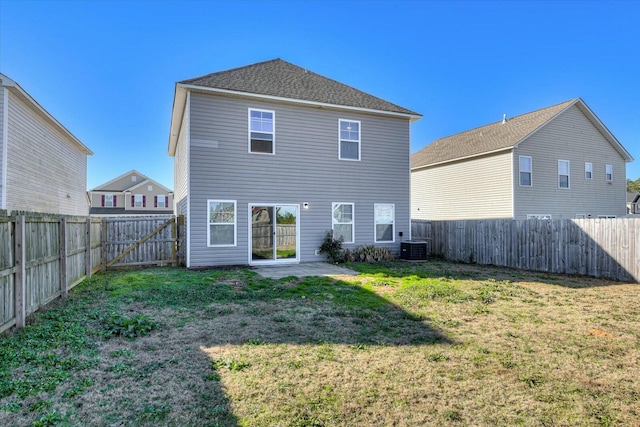 rear view of house with a patio area, a yard, and cooling unit