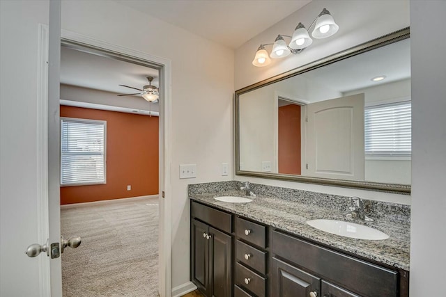 bathroom with ceiling fan and vanity