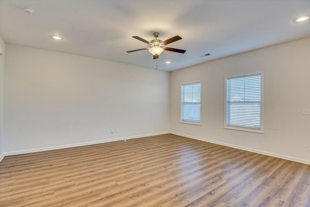 unfurnished room with light wood-type flooring and ceiling fan