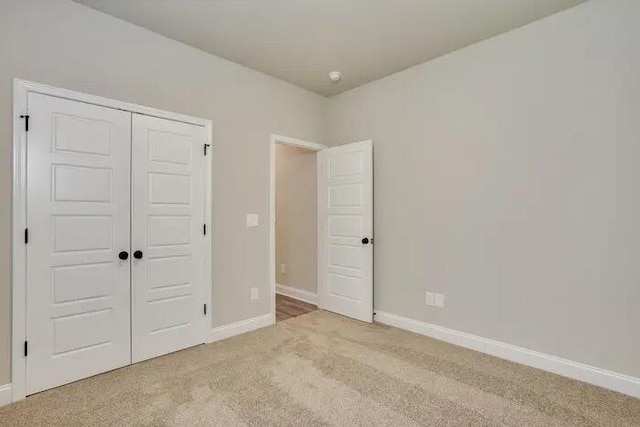 1068 Burlington Dr, Augusta, GA 30909 - unfurnished bedroom with light carpet, baseboards, and a closet
